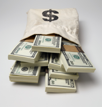Stacks of US fifty and one hundred dollar bills in money bag